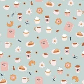 Small Coffee Croissant Scones and Cupcakes with flowers and notebooks on light blue