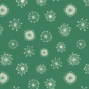 Delicate white snowflakes on a green background