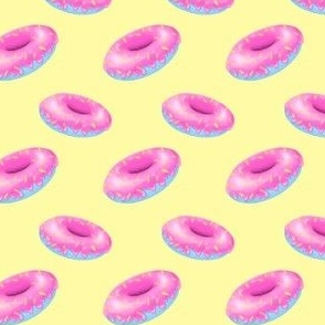 Pink and blue donuts on yellow