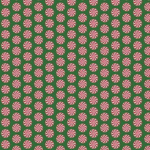 Red and White Peppermint Christmas Candy Swirls on Tree Green
