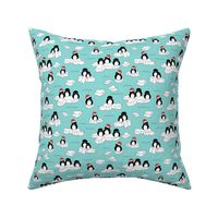 Santa christmas penguins on melting pieces of ice winter ocean ice cap animals design teal blue