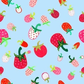 Red, pink and white strawberries on a blue background.