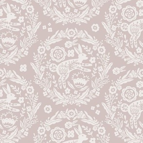 Folk Art Bunny and Floral Wreath in white on a dusty pink background 