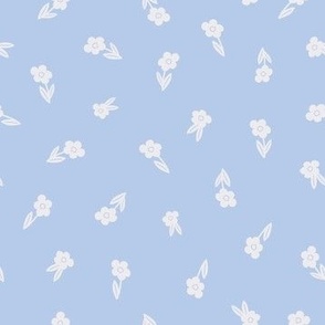 White blooming flower silhouettes tossed on baby blue