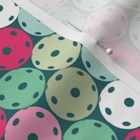 Pastel green and pink pickleballs on minty green