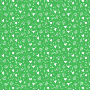 Calico pattern with hearts rainbows and stars white on green  