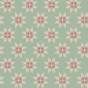 cross stitch flower on green