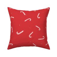 Pink and white christmas candy cane on red background. Christmas pillow. Holiday winter.