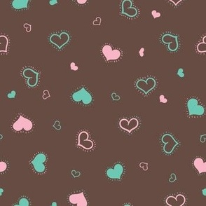 Shiny pink and green hearts on taupe brown