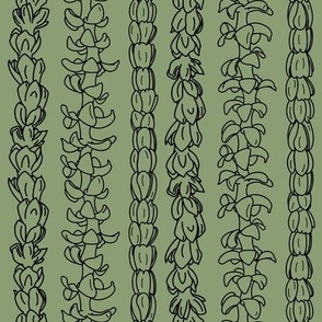 Flower lei strands on green