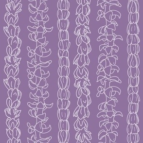 Flower lei strands on lavender 