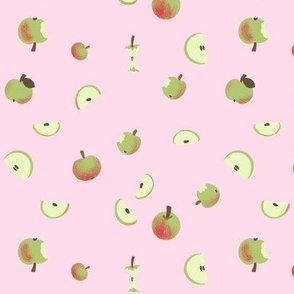 Apples and slices on pink