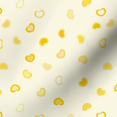 Scattered dark to Light yellow ombre hearts on a pastel yellow background