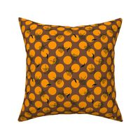 bright oranges and black flowers leaves on brown polka dots