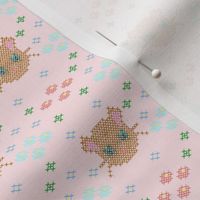 cross stich brown cat and flowers on candy colored canvas