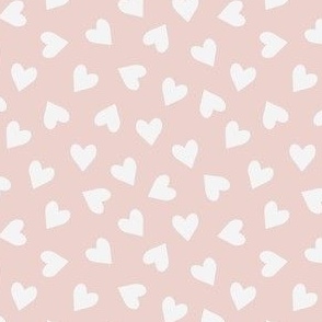 Small scale tossed white hearts on dusty pink