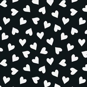 Tossed small white hearts on black