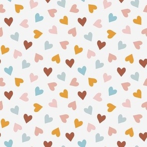 Tossed small scale Valentine hearts in boho colors on cream white