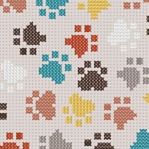Normal scale // Pawsome cross stitch // beige background yellow brown and peacock blue paw prints