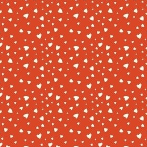 Small cream hearts on a red background