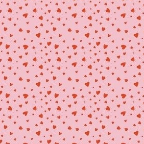 Small red hearts on a pink background
