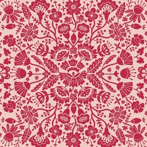 Symmetrical floral folk art pattern in viva magenta on a dusty pink background