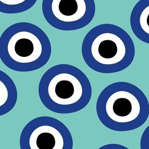 Minimalist retro evil eye - irregular large circles and dots arabic abstract symbol on turquoise teal blue