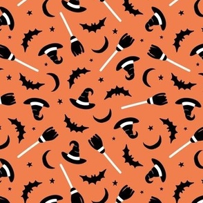 Witches hats broomstick bat stars and moon halloween design minimalist design black and white on orange