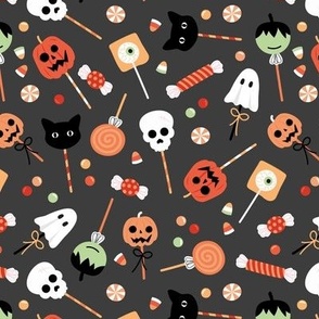 Colorful cutesy halloween lollipop - candy and sweets with skulls pumpkins ghosts cats and bloody eyes orange neutrals on charcoal gray 