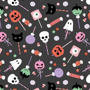 Colorful cutesy halloween lollipop - candy and sweets with skulls pumpkins ghosts cats and bloody eyes orange pink lilac on charcoal gray 