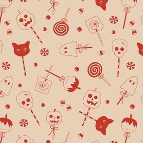 Halloween sweets and candy - ghosts cats zombies and pumpkins for fright night cutesy kawaii style lollipop vintage red on beige sand