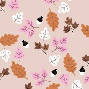 Fall leaves and nuts - autumn garden in orange pink on sand
