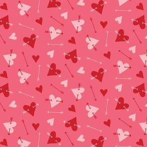 Pink and red hearts with arrows tossed on dark pink