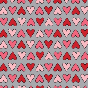 Pink and red hearts in alternating stripe pattern on gray