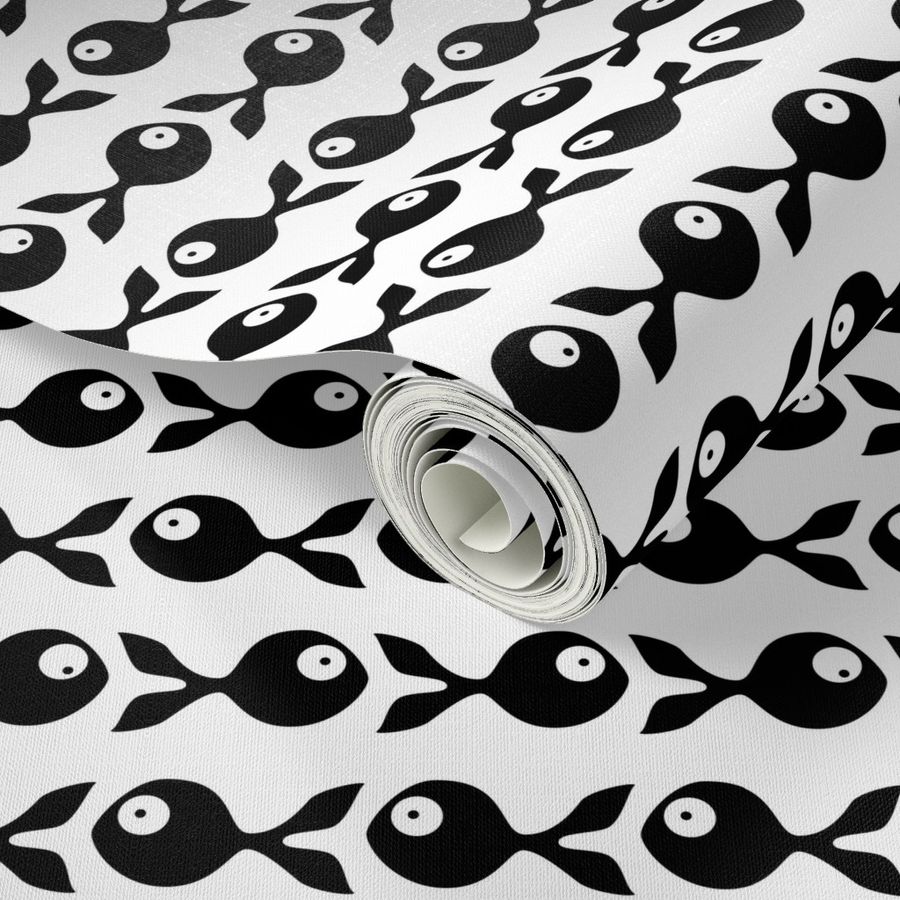 small - little fish swimming in black and white