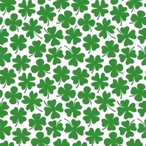 Green four leaf clovers on white