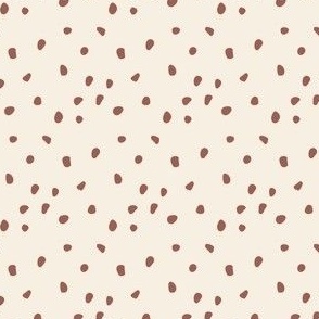 Brown Speckles on a Light Beige Background