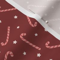 Christmas sugar canes and stars in red, cream, tan on maroon