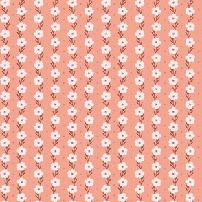 Ditsy pattern with white flowers in coral background