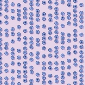 Blueberries arranged in stripes on a lilac background