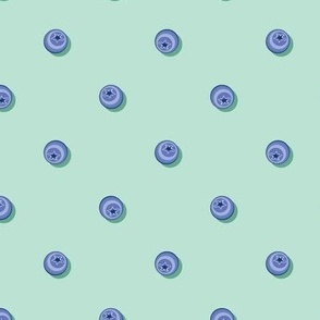 Blueberries in polka dot style on a light turquoise background