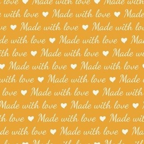 Cream white lettering "Made with love" and hearts on bright orange