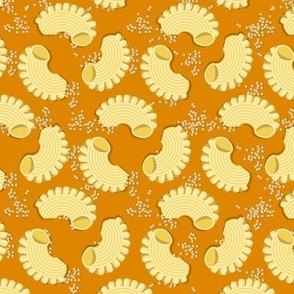 Pasta Creste di gallo and mustard seeds on an orange background, Medium scale