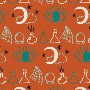 Small hand drawn halloween on burnt orange, with witches crystal ball, moon, eye, spider webs and stars