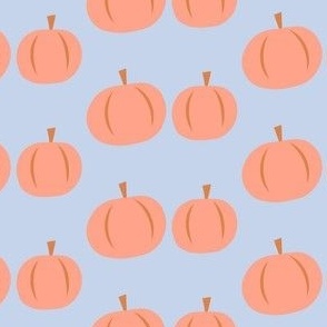 orange pumpkins on light purple background