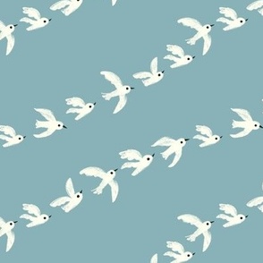 flock of birds flying in a row - blue sky