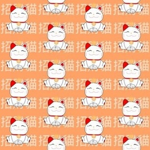 Maneki Neko lucky cats on orange 