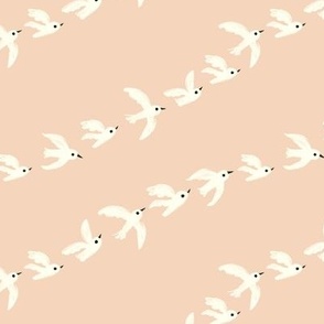 flock of birds flying in a row - light peach pink