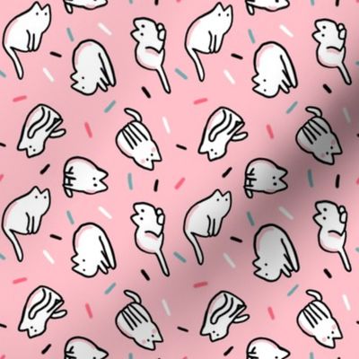 Funny white cats with confetti on pink