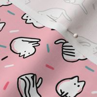 Funny white cats with confetti on pink